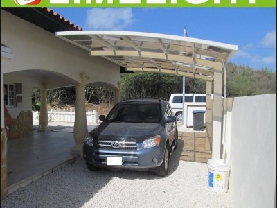 single aluminium awning with white frame and bronze polycarbonate solid roofing