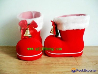 red plastic Christmas boots with bell and bow